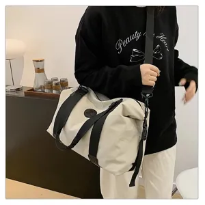Large capacity waterproof travel duffel bag for women and men, stylish shoulder luggage bag.