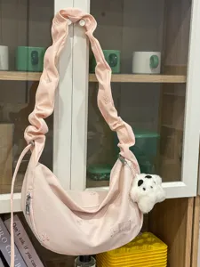 Pink ruched cloud crossbody bag with bow embroidery and cute bear pendant for daily commute.