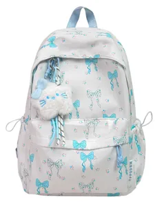 Cute Japanese style backpack for girls with blue bow pattern and plush cat pendant.