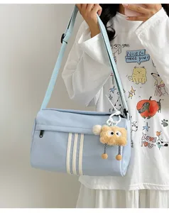 Casual large canvas crossbody bag with cute plush pendant for women daily travel sports.