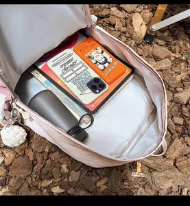 Casual pink travel backpack for women, large capacity outdoor school bag for students.