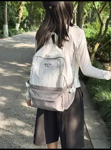 Outdoor travel casual backpack detail showing grey waterproof fabric, large capacity school bag.
