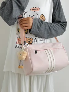 Stylish pink canvas crossbody bag casual shoulder travel purse with cute bear pendant.