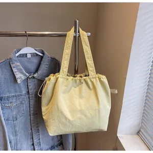Bolso tote de lona amarilla para mujer, bolso de hombro informal grande para viajes y uso diario.