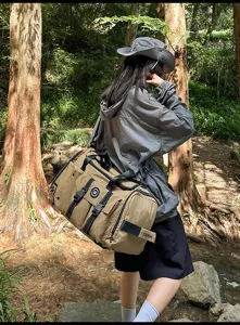 Detailed outdoor view of a large capacity khaki grid travel duffel bag with shoulder straps.
