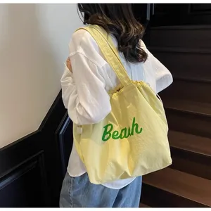 Bolso de hombro de lona amarilla con estampado verde Beah, ideal para uso diario.