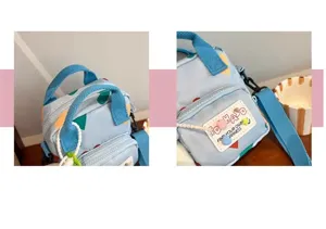 Detailed shot of light blue canvas crossbody bag with colorful print and double handles.