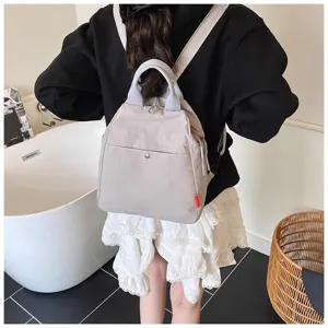 Detailed view of the casual canvas backpack showing its minimalist back design and texture.