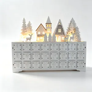 Wooden Christmas advent calendar detail view showing 24 numbered drawers and illuminated village.