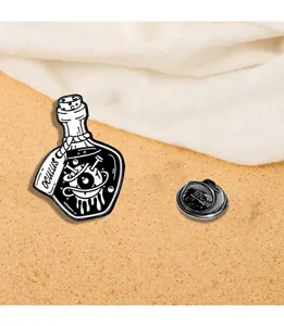 Close-up detail of gothic punk enamel pin featuring eyeball potion bottle design for clothes.