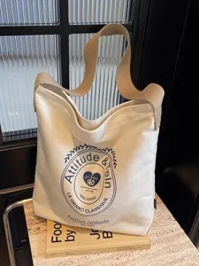 Large capacity canvas shoulder bag for women, stylish casual crossbody bag with printed design.