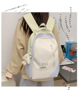 Japanese style colorblock casual backpack for school students with cute plush pendant.
