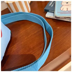 Blue canvas shoulder bag strap detail view, casual style everyday crossbody bag accessory part.