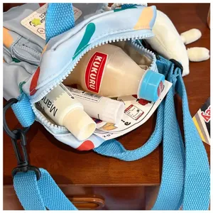 Detailed view of blue canvas crossbody bag interior capacity, casual cute style for women.