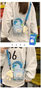 Canvas crossbody bag for women, cute cartoon design, light blue small shoulder phone bag.