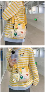 Cute cartoon canvas crossbody bag for women, trendy small shoulder bag with plush pendant.