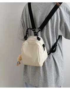 Detail shot of the lightweight mini convertible canvas backpack, adjustable straps.