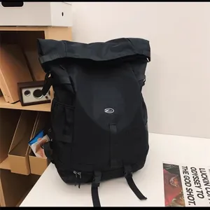 Detailed view of the large capacity black roll-top travel backpack display setup.