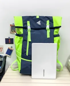 Detailed view of large capacity colorblock backpack in blue and neon yellow, sturdy outdoor gear.