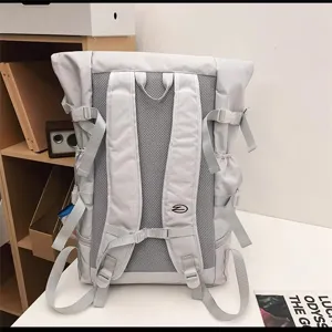 Detailed shot showing the breathable mesh back and adjustable straps of the grey backpack.