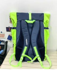 Backpack detail view showing rolltop design, neon green and dark blue color blocking straps.