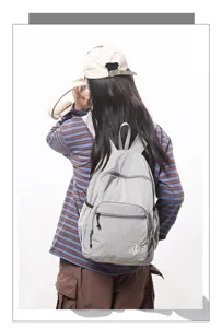 Lightweight waterproof grid backpack detail, compact casual daypack for women travel and fitness.