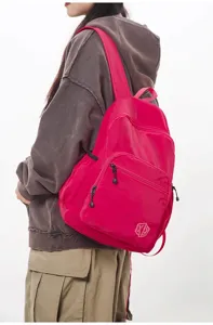 Detail view of a lightweight candy pink waterproof casual backpack showing its practical zipper pocket.