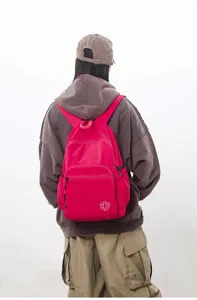 Back view detail shot of women's lightweight pink waterproof quick-drying casual travel backpack.