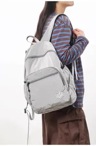 Lightweight waterproof grid backpack for women, casual minimalist travel fitness daypack.