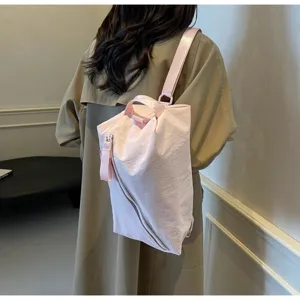 Zaino rosa con zip diagonale da donna, elegante borsa in tessuto casual con design di nicchia.