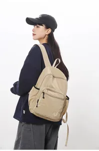Lightweight waterproof grid backpack for women, casual minimalist daypack for travel and daily use.