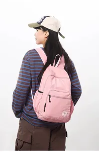 Lightweight pink waterproof backpack for women, casual foldaway travel daypack, daily use.