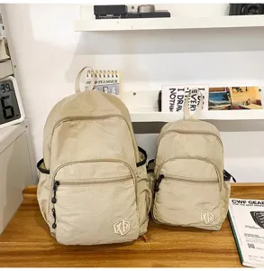 Detail shot of lightweight waterproof quick-drying backpack in dual sizes with khaki grid design.
