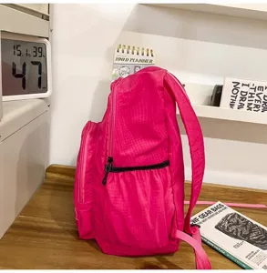 Lightweight waterproof pink grid backpack for travel and daily casual use compact style