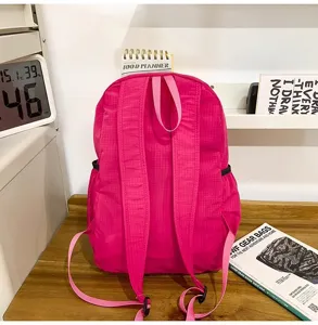 Pink folding backpack detail, lightweight waterproof fitness travel bag stylish design.