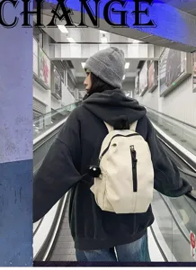 Detailed view of casual lightweight backpack worn on street, stylish daily school bag design.