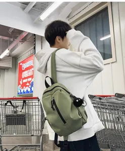 Lightweight olive green casual backpack detail, featuring durable fabric and front zipper.