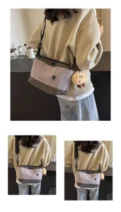 Retro casual canvas crossbody bag for women, stylish niche design messenger bag with cute plush pendant.