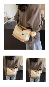 Detail view of the stylish canvas crossbody bag, featuring contrast color design and plush charm.