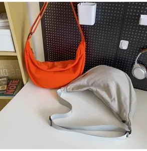 Detail view of casual nylon crossbody dumpling bag with spacious design and adjustable strap.