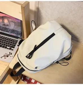 Minimalist casual backpack for daily commute and travel, lightweight fabric, versatile design.