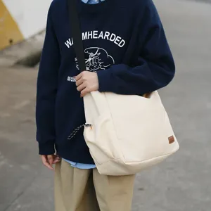 Detailed view of the casual canvas crossbody bag, featuring spacious storage and a stylish design.