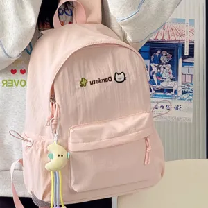 Pink cute casual backpack for women, lightweight school bag with nice pendant for daily use.