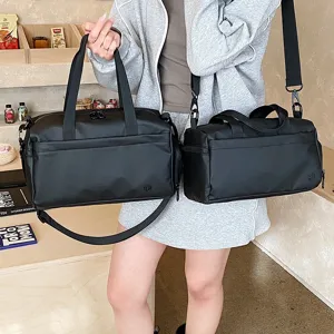 Black waterproof sports gym bag detail view, lightweight travel luggage shoulder bag.