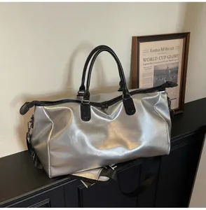 Silver metallic travel duffel bag detail, large capacity waterproof weekender bag for women.