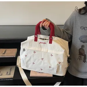 Large capacity canvas duffel bag with red handles and cute bow embroidery for travel and gym.