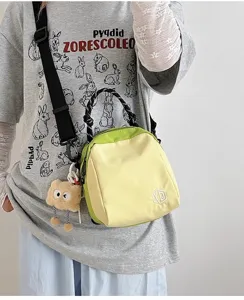 Lightweight canvas crossbody shell bag for women, stylish contrast color handbag with handle.