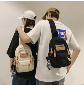 Canvas chest bag detail shot, streetwear style casual sling backpack for men and women, durable.