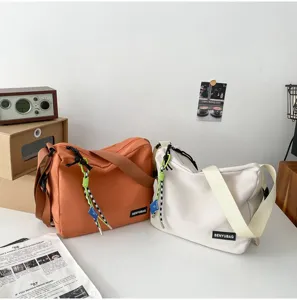 Casual Japanese style solid color canvas crossbody messenger bag for women and men daily use.