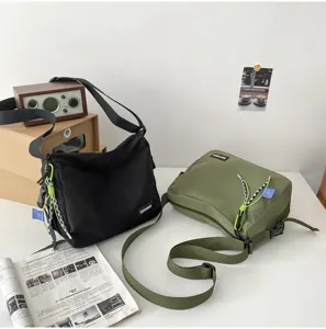 Casual canvas crossbody bag detail, showing textured fabric, adjustable strap and style.